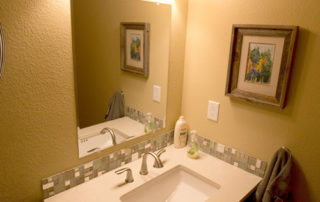 Bathroom sink, cabinet, tile, lighting