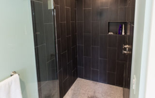 Tiled, glass enclosed shower stall