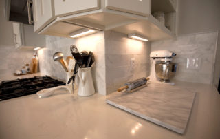 Marble tile, custom cabinetry and lighting